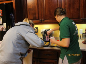 Ashley and Bree frosting cupcakes